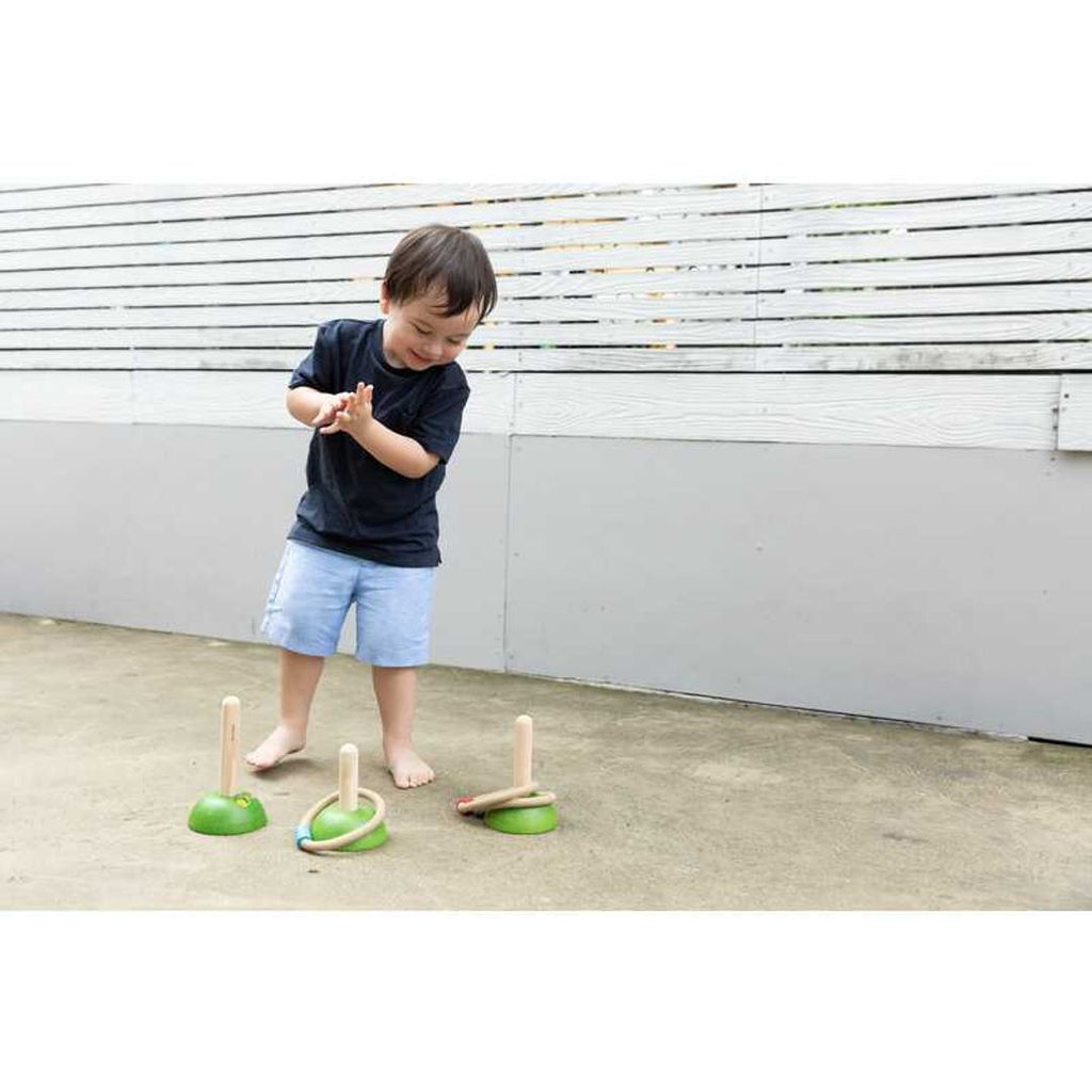 Kid playing PlanToys Meadow Ring Toss